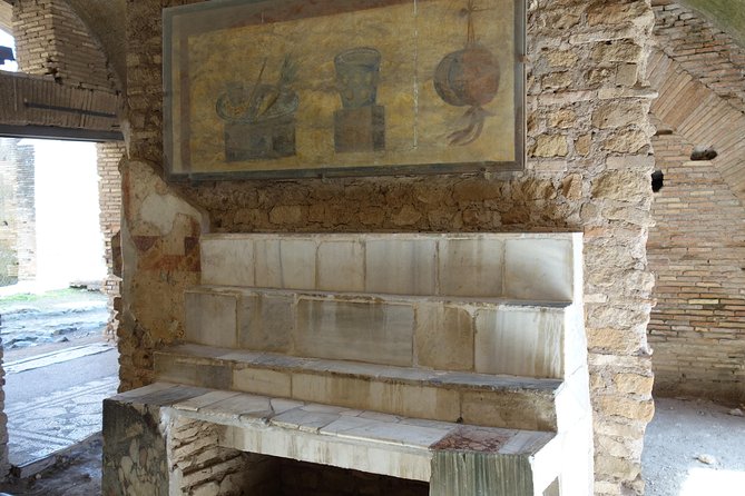 Ancient Ostia Antica Semi-Private Day Trip from Rome by Train with Guide - The amphitheater, temples, and Forum of the Corporations