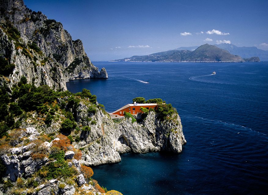 Capri: Island Boat Tour with Blue Grotto Stop - Punta Carena Lighthouse marks the western turn